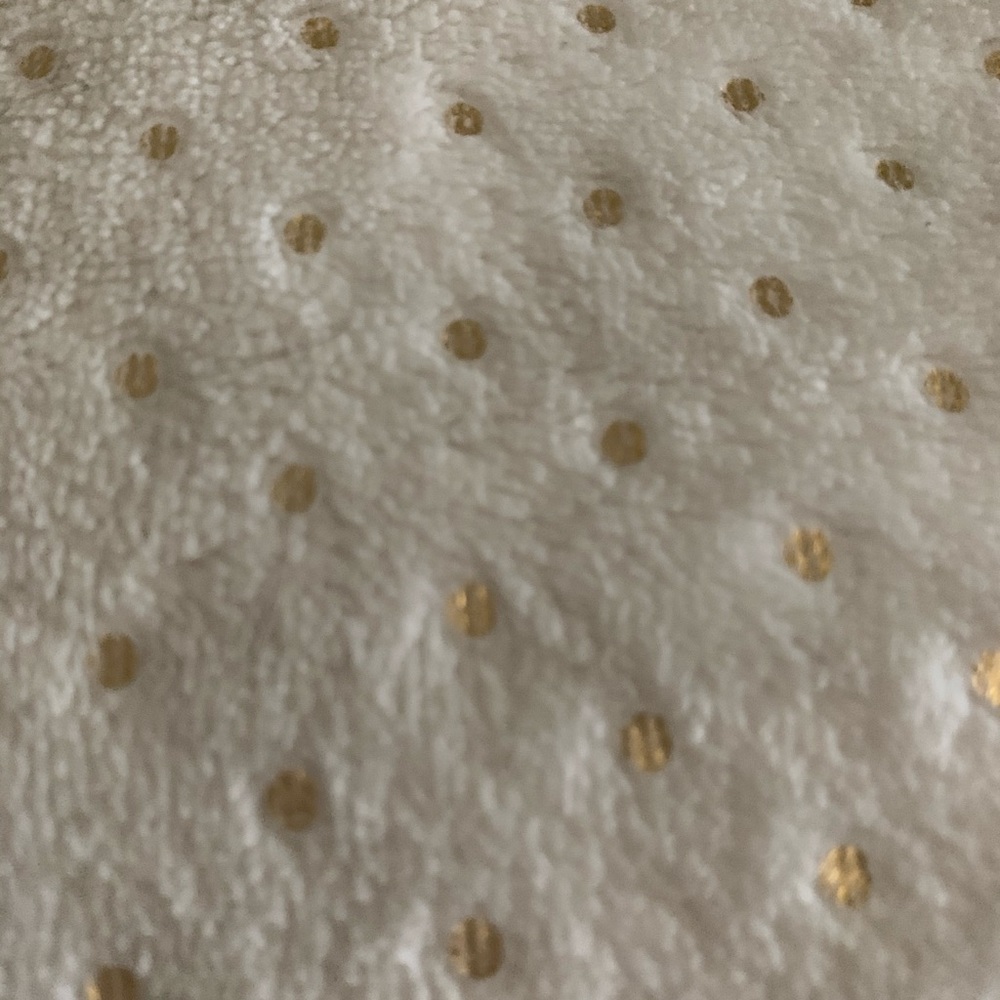 White throw with gold dots